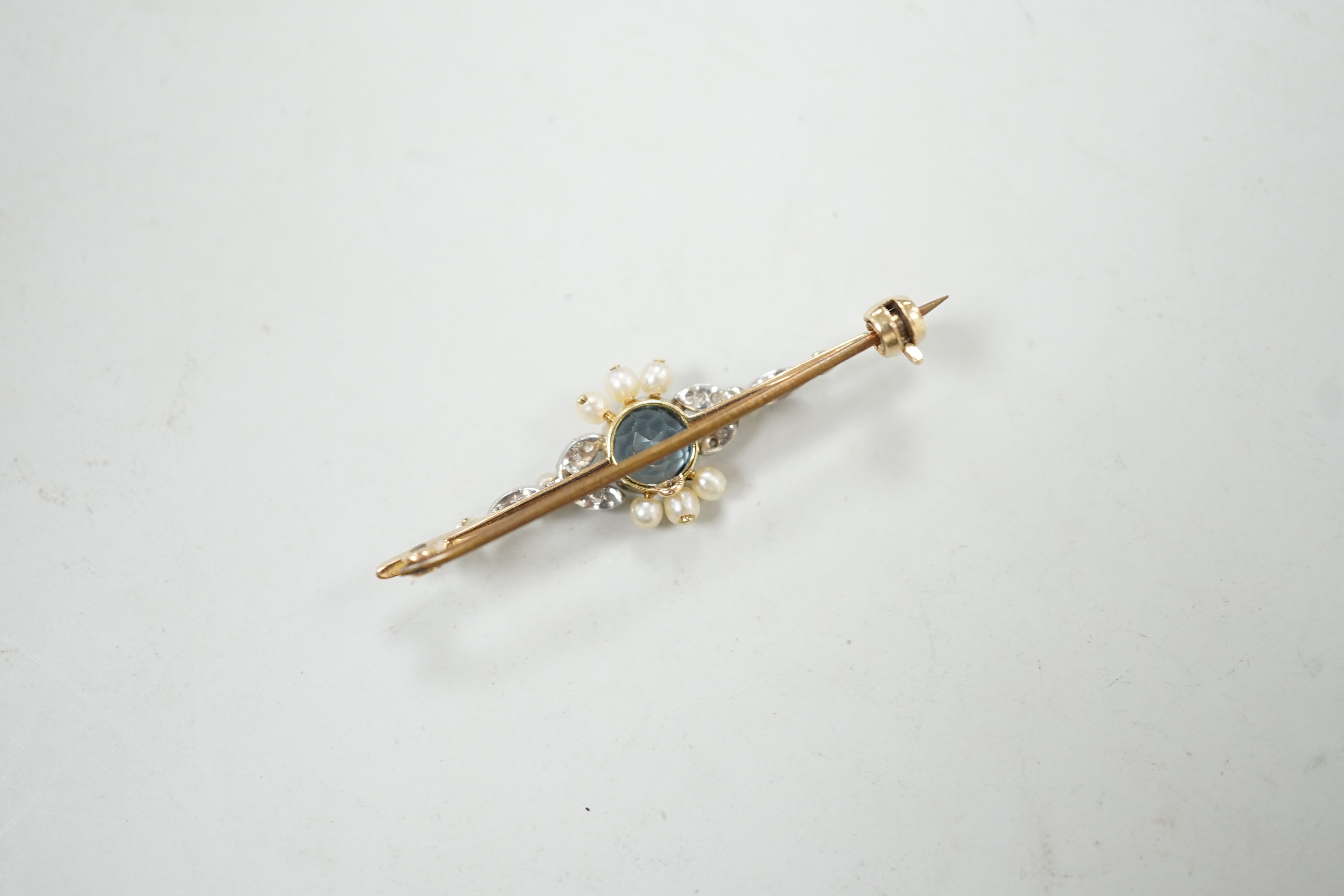 An Edwardian yellow metal, aquamarine, diamond and seed pearl set bar brooch, 40mm, gross weight 3 grams.